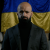 thumb-Masi Nayyem in a suit against the background of the Ukrainian flag.